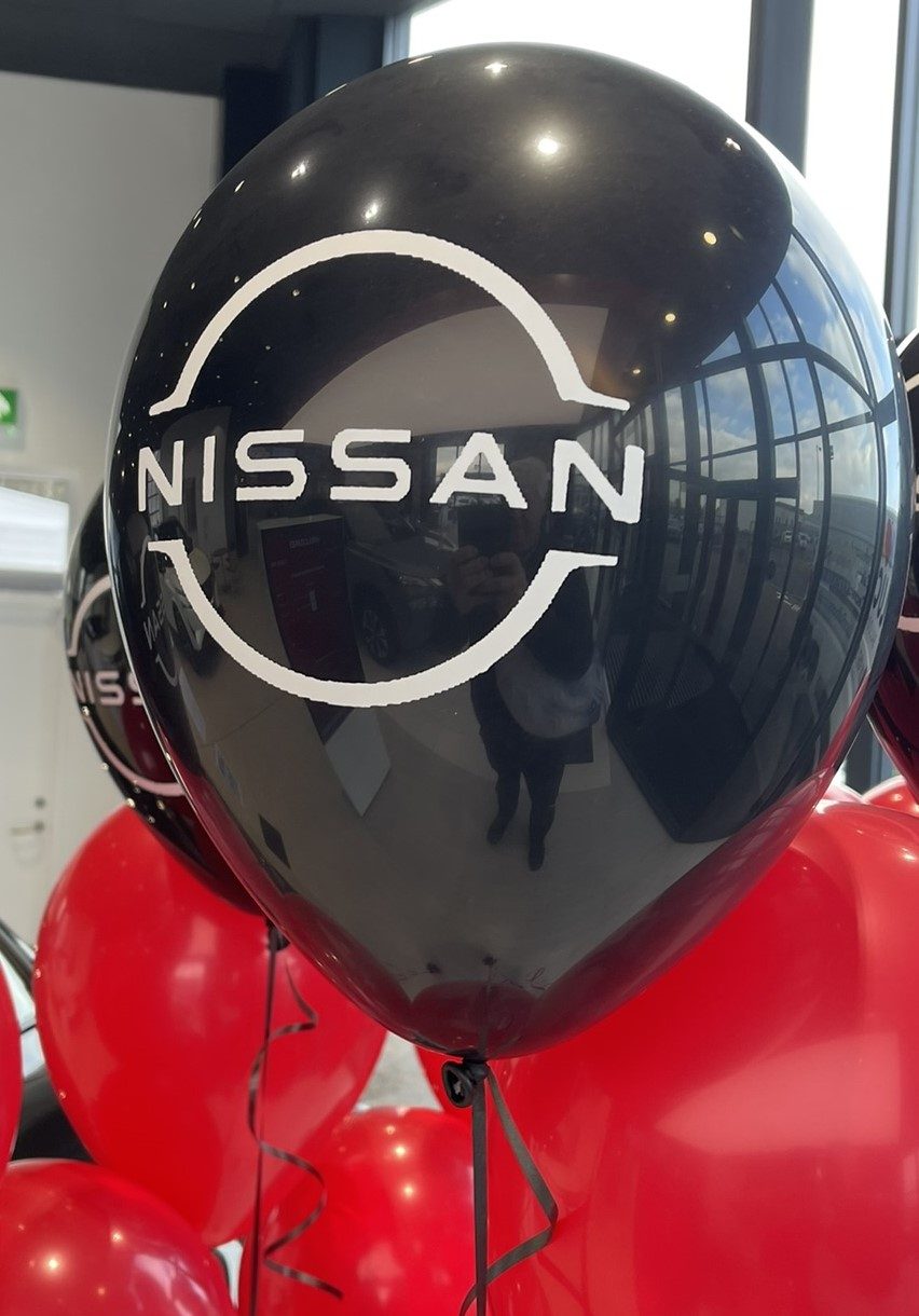 Nissan logo printed on black balloons