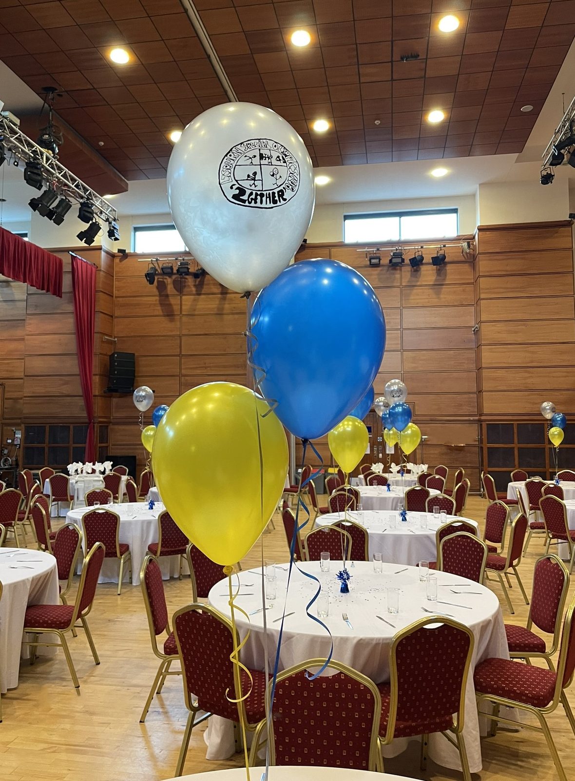 Pearl yellow, blue and silver balloons with the Lisburn Special Olympics Club logo printed on the silver balloon
