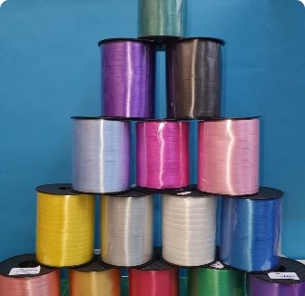 Rolls of coloured curling ribbon for tying helium balloons